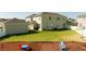 Large backyard with a lush lawn, charming seating area, and well-maintained landscaping, perfect for outdoor living at 10038 Verse Aly, Winter Garden, FL 34787