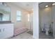 Bright bathroom with a glass shower and a comfortable pink bench at 10038 Verse Aly, Winter Garden, FL 34787