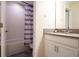 Bright bathroom with a shower and tub combination, a vanity with white cabinets, and a mirror at 10038 Verse Aly, Winter Garden, FL 34787