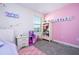 A bedroom with pink accents and a white bookshelf at 10038 Verse Aly, Winter Garden, FL 34787