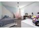 Teen bedroom with modern accents, hanging chair, and spacious desk at 10038 Verse Aly, Winter Garden, FL 34787