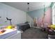 Bedroom with hanging chair, and a fish tank set up on the white table at 10038 Verse Aly, Winter Garden, FL 34787