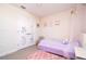 A bedroom with fun decor and a lavender bedspread at 10038 Verse Aly, Winter Garden, FL 34787