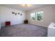 Bright bedroom with two windows that offer outside views and neutral carpet at 10038 Verse Aly, Winter Garden, FL 34787