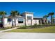 Community clubhouse featuring stone accents, well-manicured lawn, and mature palms at 10038 Verse Aly, Winter Garden, FL 34787