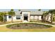 Inviting community clubhouse featuring a covered entrance, stone accents, and well-maintained landscaping at 10038 Verse Aly, Winter Garden, FL 34787