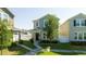 Attractive two-story home with a well-manicured lawn, front porch, and lush greenery enhancing curb appeal at 10038 Verse Aly, Winter Garden, FL 34787