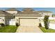 Spacious garage with well-kept landscaping, showcasing a clean driveway and enhancing property appeal at 10038 Verse Aly, Winter Garden, FL 34787
