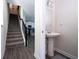 Hallway view of stairs and a half bath featuring stylish flooring and convenient layout at 10038 Verse Aly, Winter Garden, FL 34787
