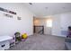 Hallway with carpet, a black decorative railing, and natural light from a window at the landing at 10038 Verse Aly, Winter Garden, FL 34787