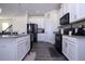 Close up of the kitchen features stainless steel appliances and white cabinetry at 10038 Verse Aly, Winter Garden, FL 34787