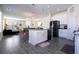 Open-concept kitchen boasts a center island, stainless appliances, and sleek gray flooring at 10038 Verse Aly, Winter Garden, FL 34787