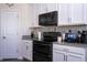 White kitchen cabinets and stainless steel appliances provide a sleek modern aesthetic at 10038 Verse Aly, Winter Garden, FL 34787