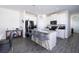 The kitchen features white cabinets, stainless steel appliances, and an island with bar seating at 10038 Verse Aly, Winter Garden, FL 34787