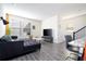 Open-concept living room with a large sofa, modern decor, and plenty of natural light at 10038 Verse Aly, Winter Garden, FL 34787