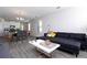 Spacious living area showcases open concept with sectional, dining area and modern kitchen at 10038 Verse Aly, Winter Garden, FL 34787