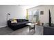 Bright living room with comfortable seating, modern decor, and large windows for natural light at 10038 Verse Aly, Winter Garden, FL 34787