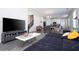Open-concept living room features a sectional sofa, modern decor, and a view of the dining area and kitchen at 10038 Verse Aly, Winter Garden, FL 34787