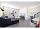 Open-concept living room with a large sofa, modern decor, and plenty of natural light at 10038 Verse Aly, Winter Garden, FL 34787