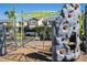 Community playground with climbing apparatus and monkey bars surrounded by modern townhomes in a Gathering-friendly neighborhood at 10038 Verse Aly, Winter Garden, FL 34787