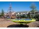Community playground boasts a web climber and merry-go-round, perfect for active play and outdoor fun at 10038 Verse Aly, Winter Garden, FL 34787