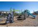 A community playground with climbing walls and slides is designed for active fun, nestled amongst modern townhomes at 10038 Verse Aly, Winter Garden, FL 34787
