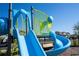 Community playground features a slide and climbing area, providing a fun and safe play space for children at 10038 Verse Aly, Winter Garden, FL 34787