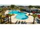 Aerial view of a resort-style pool offering abundant lounge seating, umbrellas, and a spacious pool deck at 10038 Verse Aly, Winter Garden, FL 34787