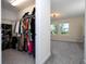 Spacious walk-in closet leads to a bedroom with a sitting area and large windows with trees outside at 10038 Verse Aly, Winter Garden, FL 34787