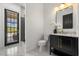 Bathroom features a marble floor and vanity, white walls, and access to the pool at 11019 Kentmere Ct, Windermere, FL 34786