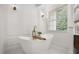 Elegant bathroom featuring a freestanding tub, modern fixtures, and marble accents at 11019 Kentmere Ct, Windermere, FL 34786