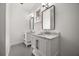 Bright bathroom with dual vanities featuring marble countertops, framed mirrors, and modern lighting fixtures at 11019 Kentmere Ct, Windermere, FL 34786