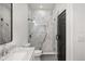 Stylish bathroom with marble tile shower featuring a glass door, sleek fixtures, and a modern sink and vanity at 11019 Kentmere Ct, Windermere, FL 34786