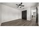 Neutral bedroom featuring a ceiling fan and wood-look flooring at 11019 Kentmere Ct, Windermere, FL 34786