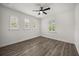 Bright bedroom featuring three windows and a ceiling fan at 11019 Kentmere Ct, Windermere, FL 34786