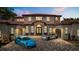 Stunning two-story home with red tile roof, arched windows, grand entrance, and two sports cars in the brick driveway at 11019 Kentmere Ct, Windermere, FL 34786