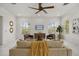 Comfortable living room with neutral furniture, marble floors, and natural light, perfect for relaxation at 11019 Kentmere Ct, Windermere, FL 34786