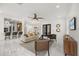 Open-concept living room with white marble floors, a ceiling fan, bar seating, and modern decor at 11019 Kentmere Ct, Windermere, FL 34786