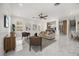 Spacious living room with marble floors, neutral furniture, and an open floor plan at 11019 Kentmere Ct, Windermere, FL 34786