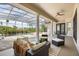 Inviting patio with stylish furniture overlooking a screened pool and lush landscaping at 11019 Kentmere Ct, Windermere, FL 34786