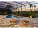 Beautiful pool with a screened enclosure and beautiful sunset views at 11019 Kentmere Ct, Windermere, FL 34786