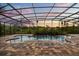 A luxurious screened pool surrounded by beautiful pavers and lush greenery at 11019 Kentmere Ct, Windermere, FL 34786
