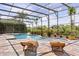 Beautiful screened pool with brick patio and lush tropical landscaping at 11019 Kentmere Ct, Windermere, FL 34786