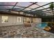 Rear exterior showing patio, screened pool area, and beautiful landscaping at sunset at 11019 Kentmere Ct, Windermere, FL 34786