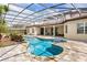Backyard pool featuring stone trim, screened enclosure, and patio with outdoor seating at 11019 Kentmere Ct, Windermere, FL 34786