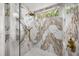 Beautiful shower with marble tile, glass enclosure, and rainfall shower head at 11019 Kentmere Ct, Windermere, FL 34786