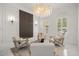 Chic sitting room with shuttered windows and a modern crystal chandelier at 11019 Kentmere Ct, Windermere, FL 34786