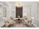 Elegant sitting room featuring a crystal chandelier and stylish decor elements at 11019 Kentmere Ct, Windermere, FL 34786
