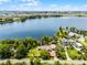 Aerial shot of a large lakefront estate, showcasing lush landscaping and stunning water views at 11632 Lake Willis Dr, Orlando, FL 32821