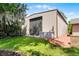 Metal barn featuring a roll-up door, complemented by a hot tub on a well-maintained lawn at 11632 Lake Willis Dr, Orlando, FL 32821